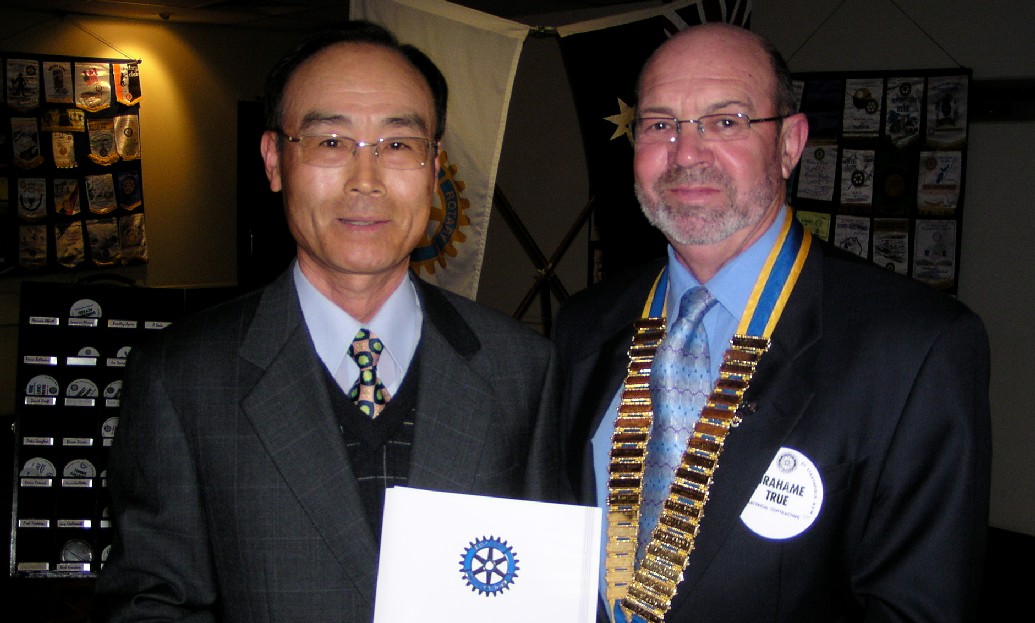 Joseph Kim being inducted by President Grahame True