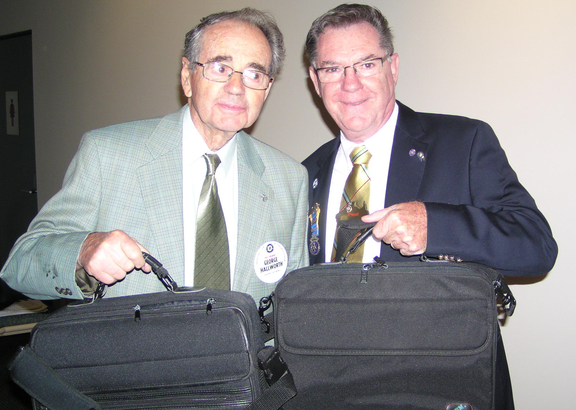 Past President George Hallworth representing Strathfield School for Seniors accepting laptops from District Governor Paul Reid